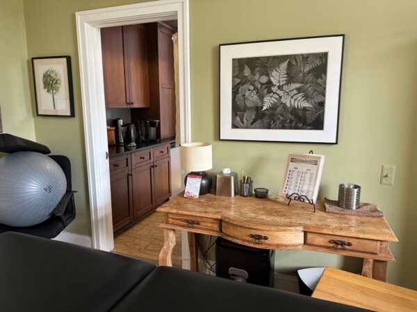 Office desk with supplies in a cozy room.