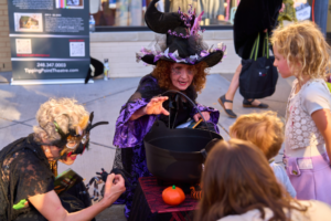 Witches performing for children on Halloween