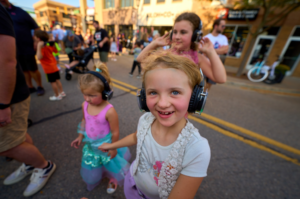 Children wearing headphones at an outdoor event